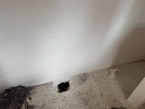 hole in terrazo floor in st petersburg showing a leak